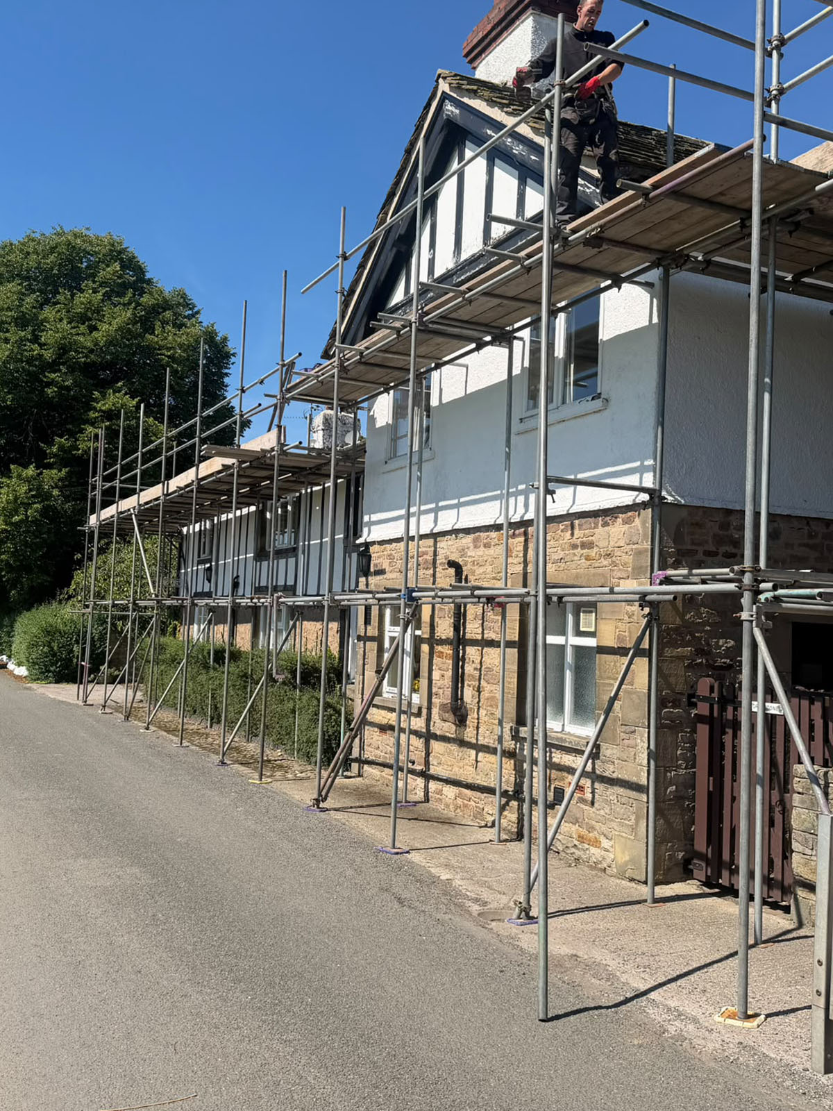 Scaffolding along a domestic property providing access to the roofline