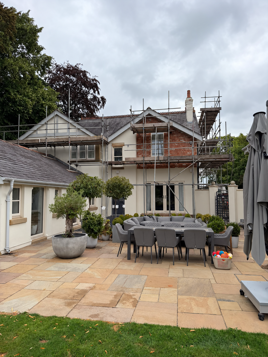 Scaffolding around a house for access to upper elevations and chimney